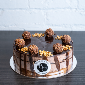 Indulge in the lavish symphony of chocolate and hazelnut with our Ferrero Mousse Whole Cake.